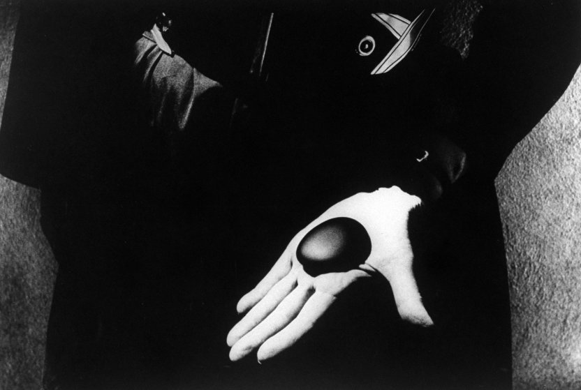 Artist Georgia O'Keeffe holding one of her favorite stones (Eliot Porter's rock) in her palm.